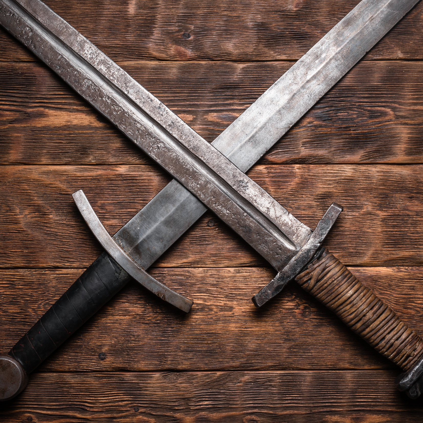 Ancient swords crossed on a table by Dmitriy on Adobe Stock